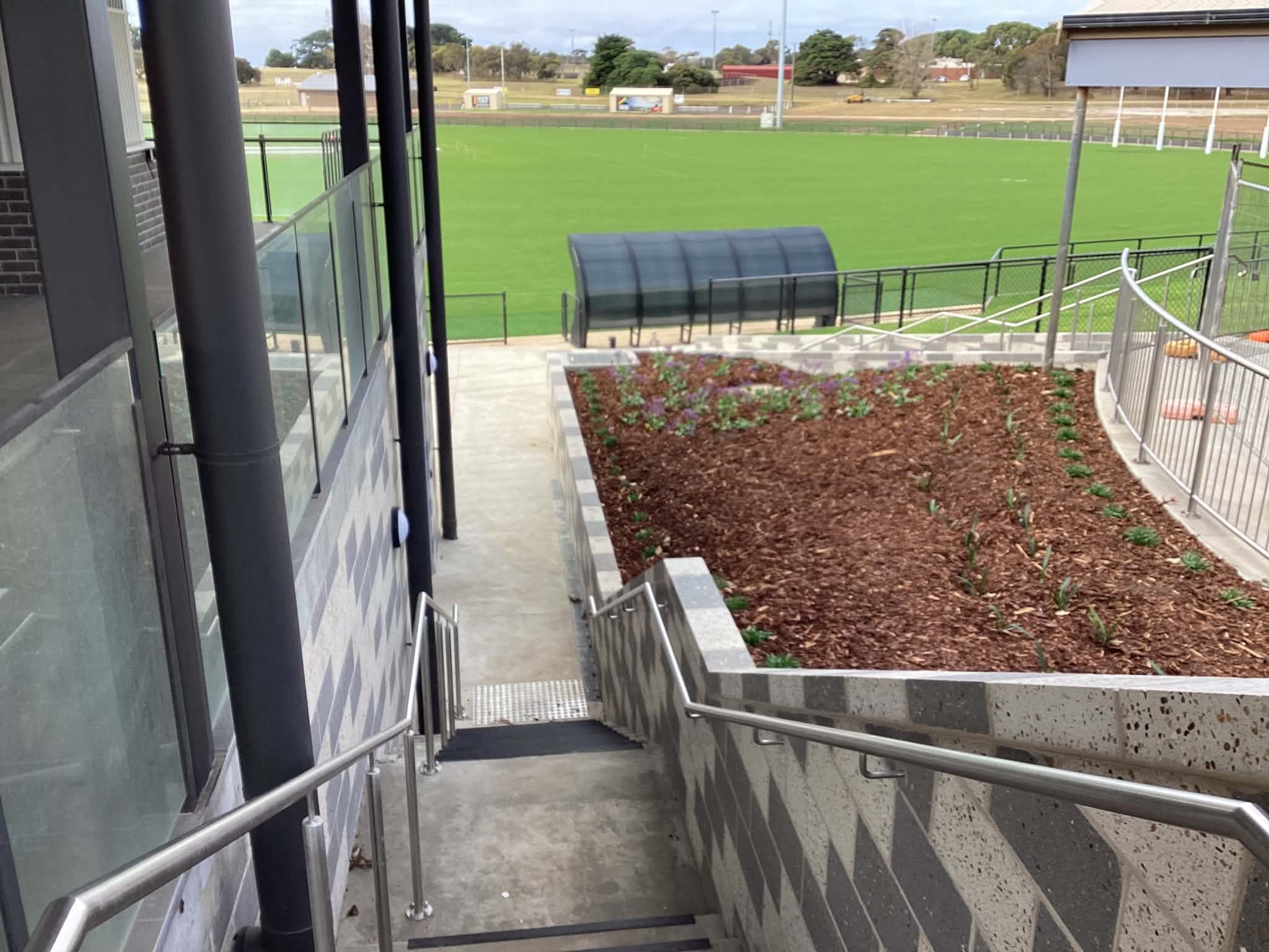Stainless handrail and balustrade work installed beside a building access path