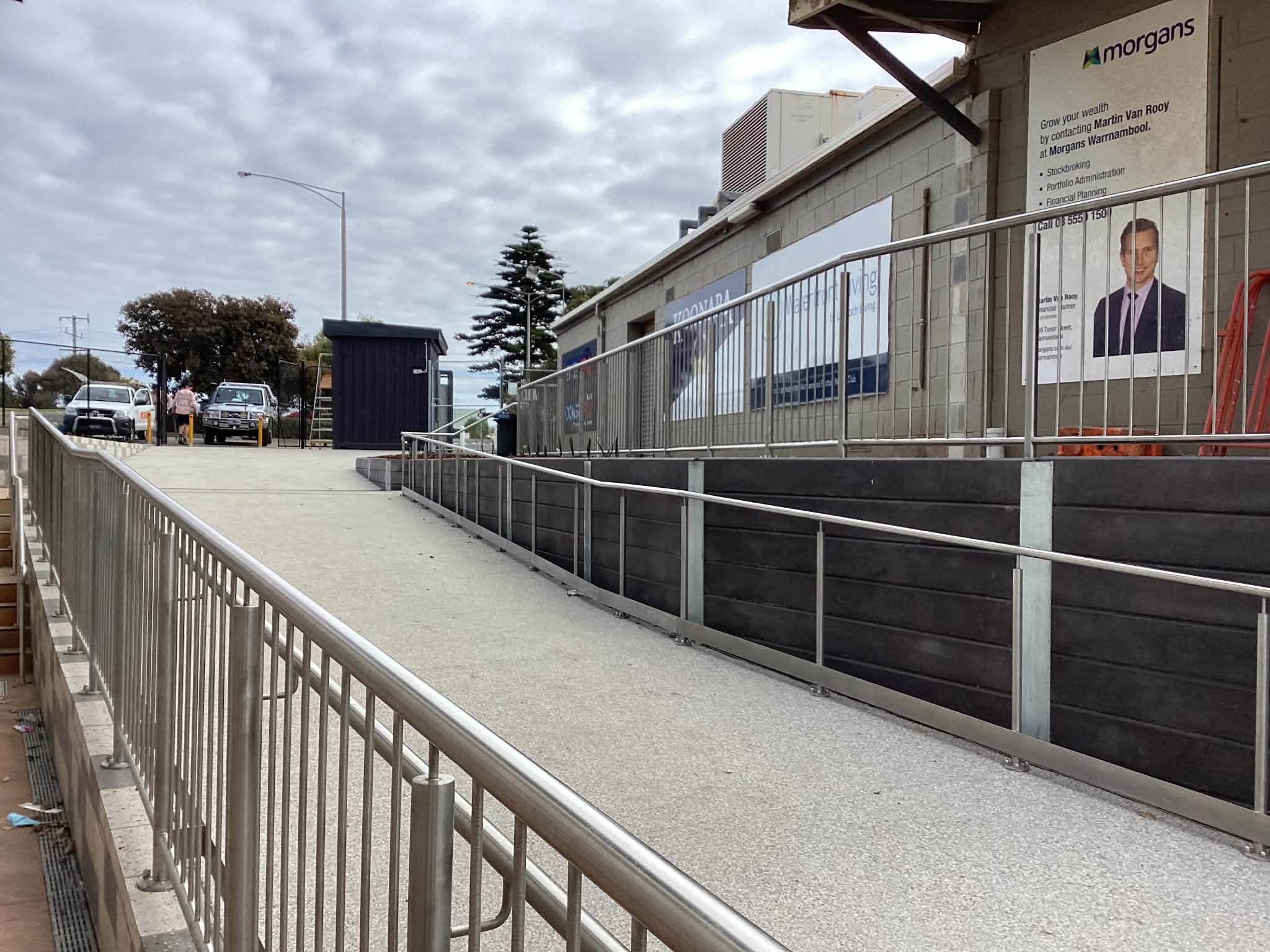 Stainless railings installed around an upper level commercial entry