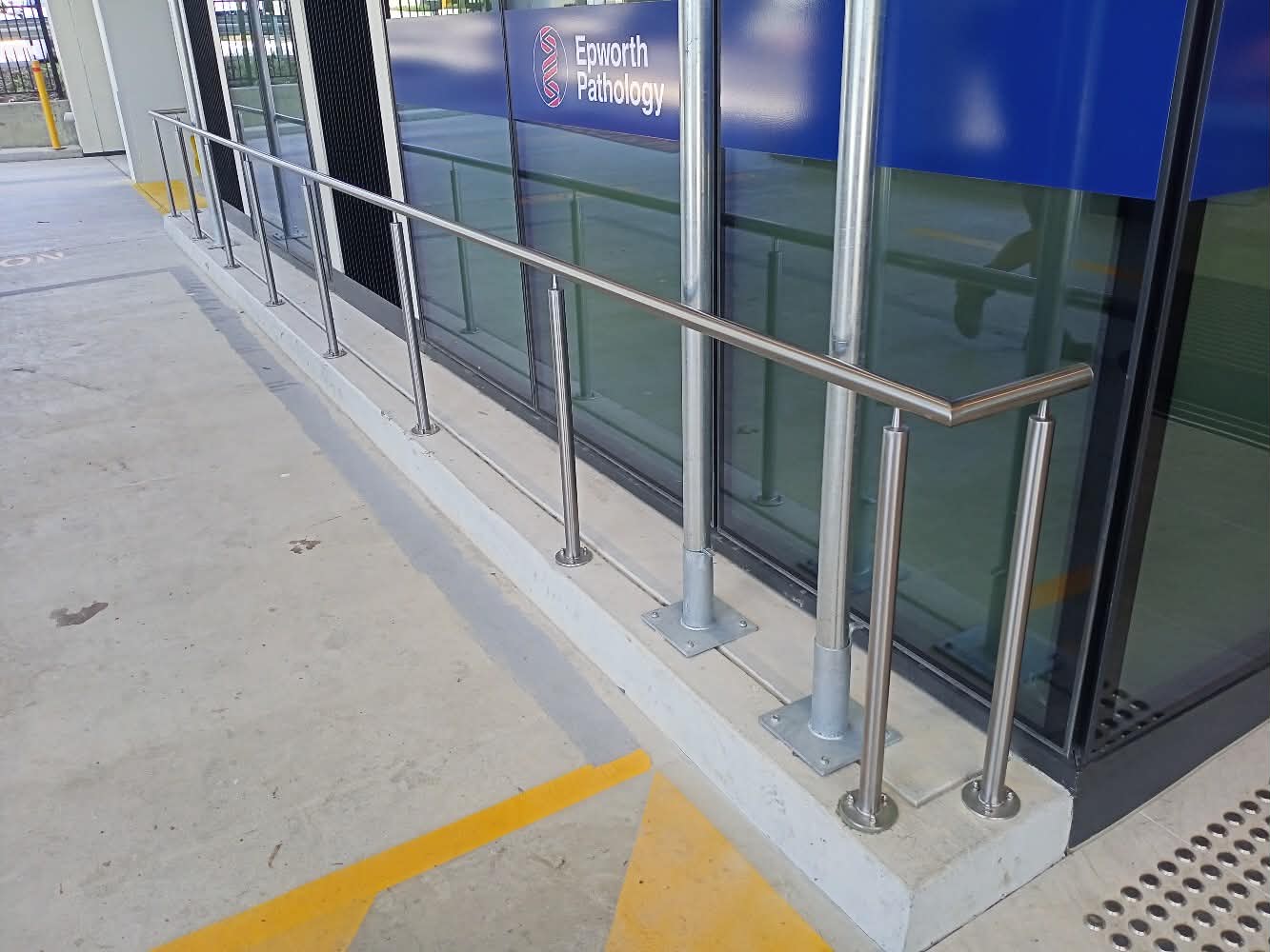 Polished stainless rail outside a pathology clinic